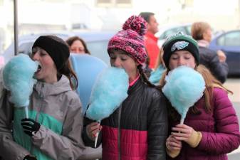 Girls enjoy blue cotton candy at the Lake Mohawk German Christmas Market.