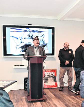 Marine veteran Robert Tagliabue speaks.