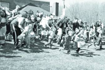 An they're off! Children rush out into the field to search for colored eggs.