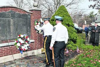 Sparta police plant a wreath.