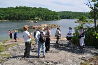 Hikers enjoy the beauty of the Butler Reservoir from an overlook.