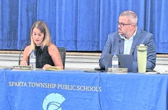 Sparta Public Schools Board of Education President Kaitlin Gagnon, left, speaks as Superintendent Matthew Beck looks on.