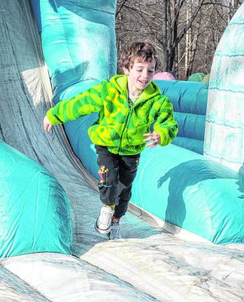 Mikey Long plays on the bounce house.