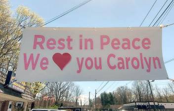 A sign hangs over Route 206 in Andover remembering Carolyn Kazar.
