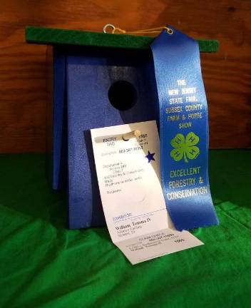 Blue ribbon birdhouse on display in the Shotwell 4-H Building, made by William Teitsma, IV of the 4-H Group "Allons-y Caching".