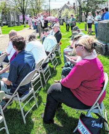 <b>Attendees watch the dedication.</b>