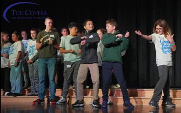 <b>Students perform on stage.</b>