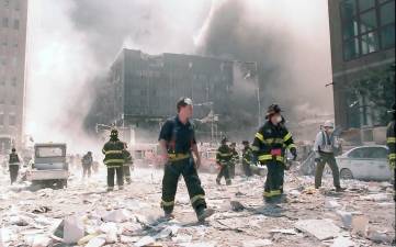 New York City firefighters work near the area known as Ground Zero after the collapse of the Twin Towers on September 11, 2001.