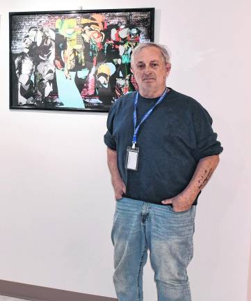 <b>Prof. Michael Hughes stands next to his art, entitled Calling Doctor Howard.</b>