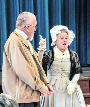 Martha Washington instructs Joe Warner on proper bowling technique.