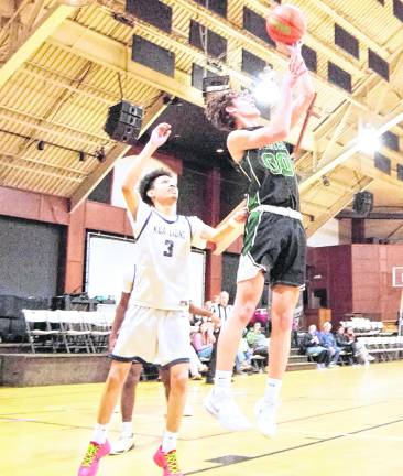 Veritas Christian's Bobby Meara handles the ball during a shot. Meara scored 3 points.
