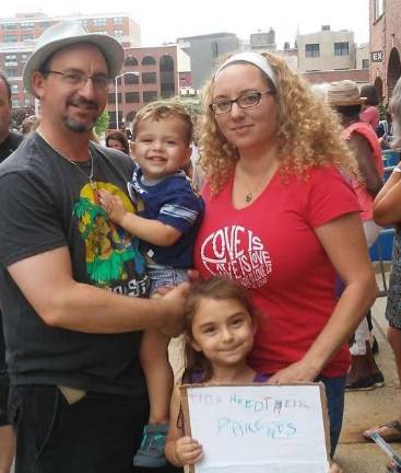 Verona residents Howard Kreiger and Marci Maccarelli, with kids, at June 22 protest Photo by Meghan Byers