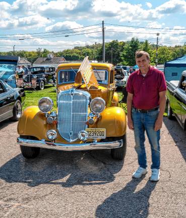 George Parichuk with a 1934 gold Chrysler.