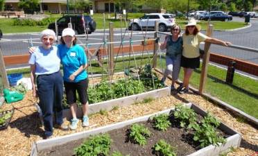 Volunteers Mary Spector, Marie Wilson, Claudia Kunath and Anita Schweizer are among the many seasoned gardeners who design and maintain the community gardens at Project Self-Sufficiency.