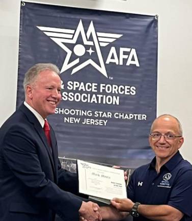 Col. Joseph Abegg, New Jersey state president of the Air &amp; Space Forces Association, congratulates Sparta High School teacher Mark Meola, right. (Photos provided)