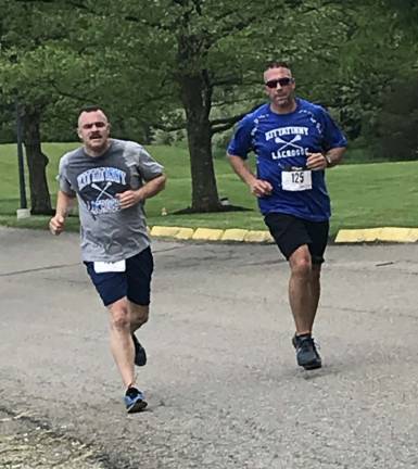 Jeff Riva (left) and Chris Shotwell (right) are coaches for the Kittatinny Youth Lacrosse Club. They and about a dozen lacrosse players represented the club in the race.