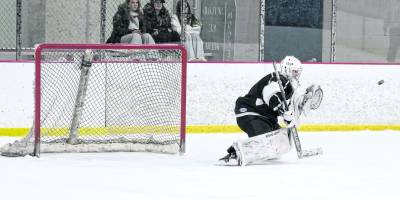 K.J.S. United's goalie Stefan Filewicz drops down to intercept the incoming puck. Filewicz made 27 saves.