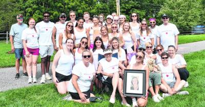 Maddie Sacchiero holds a photo of her mother, Mel Sacchiero.