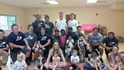 Pope John Seniors, (left to right) Joe Furmolt, Sam Howson, Steve Adams, Colin Myles, Sekayi Rudloph, Matteo Zappato, Trevor Moore, Andrew Nieves. Standingback row Brian Klemba, Zach Coccio, Coach Brian Carlson, Wayne Patterson, and Sonny Abramson with Little Sprouts students and staff.