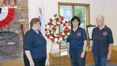 The ceremony was organized by squad member Arlene Kayne (center) with help from members Janice Johnson (left) and Renee Ferguson (right) (Photo provided)