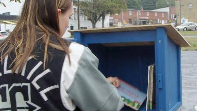 Riley Cunniffe at a Little Free Library in Sussex County (Photo by Janet Redyke)