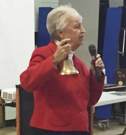 The writer demonstrates a concept at Alpine Elementary's assembly by ringing a bell.