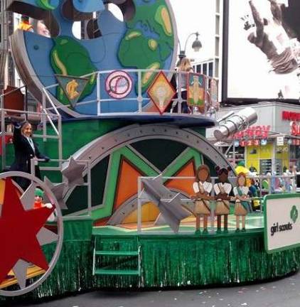 Cora on the Girl Scout float in Macy's Thanksgiving Day Parade. See her peeping out from behind the wheel?