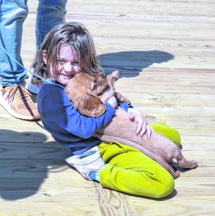 Abigail Ryan holds a dog, Cooper.