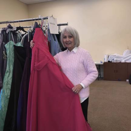 Judy Dunn of Sparta works on the dress racks