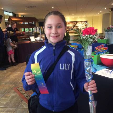 Giant gymnast Lily Sauchelli, of Newton, was pleased with her performance. Photo by Laurie Gordon