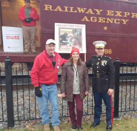 From left, John Sobotka of Toys for Tots, Katelyn Leondi of Train Creative and Major Chris Bolidura of the U.S. Marine Corps.