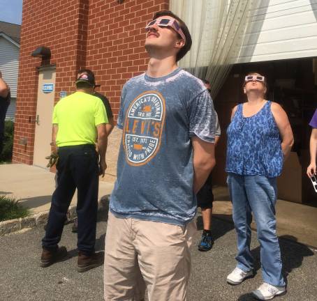 PHOTO BY LAURIE GORDONEmployees from Thor Labs, in Newton, were given eclipse glasses and the opportunity to head outside to view the eclipse. Employee Cameron Matulewski, of Tranquility, enjoyed the view.