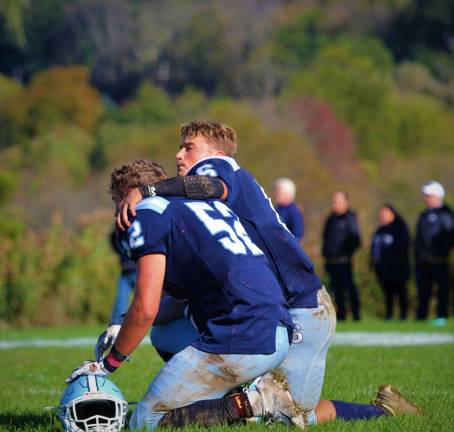 Timmy Sember is comforted by Kenny Oelkers as the reality of the Spartan's loss and the end of the season settles on the team. (photos by shannon Kuratli).