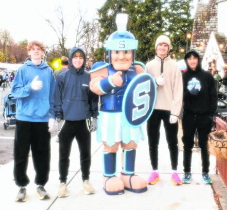 Rowan Henrie, Hayden Kopco, Jack Wittenmier and Tim Mudrick, all of Sparta, are shown with the Sparta Township High School mascot.