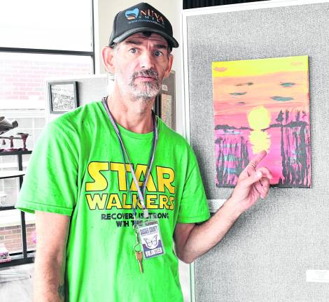 <b>John Pierro of Newton stands beside his painting, Sunset Boulevard.</b>