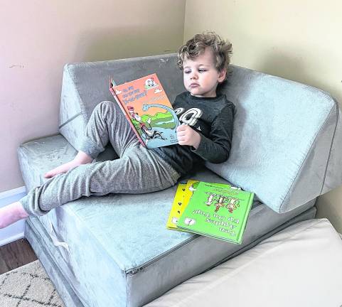 Jameson Murphy reads a book by Dr. Seuss.