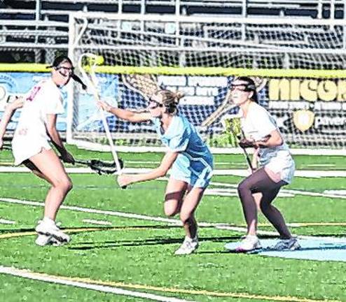 Sparta's Grace Johnson attempts to catch the airborne ball using her crosse in the first period. Johnson made 1 assist and scooped up 2 ground balls (GB).