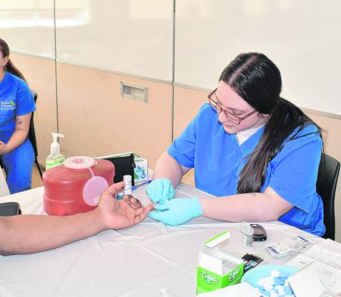 Emma Verniero of Newton checks blood for cholesterol.