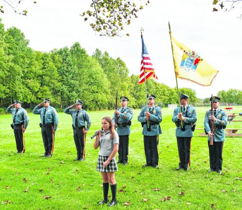 Piper McCarrick sings the national anthem.