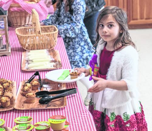 Charlotte Hayden, 5, helpsherself to breakfast.