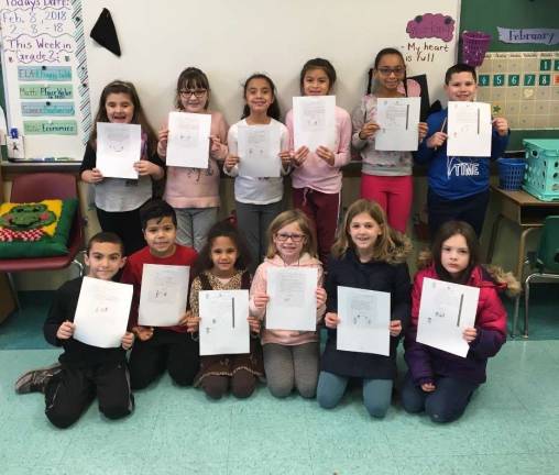 Photos provided Students at Netcong Elementary School display the letters they sent to an 8-year-old boy in Vietnam named Thinh.