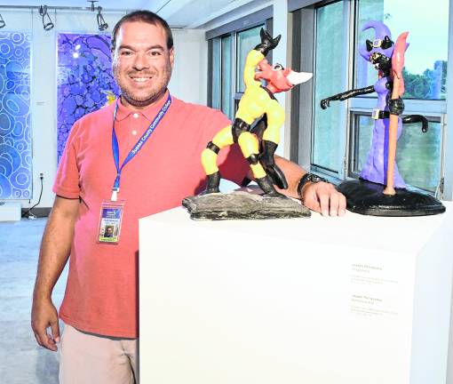 <b>Prof. Jospeh Petraccoro stands next to his sculptures, Voodoorella and Humanoid Bull.</b>