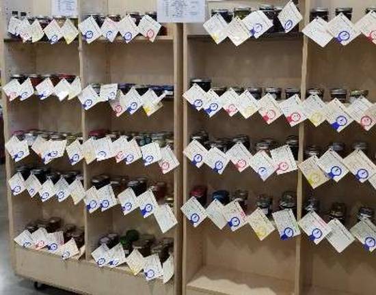 Shelves of home-canned goods, including jams, jellies, and pickles, are on display in the Richards Building.