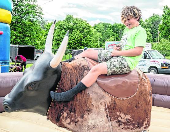 <b>Broghan Wnuk rides a mechanical bull.</b>