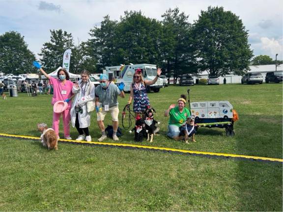 Winners in the costume contest, from left, are in second place Gianna, Preston and Joanne Macon and their dog Maple as grandma and nurses; in third place Beau and Bowie as wedding dates; and in first place Packers the grateful dog and owner Elena Philolius.