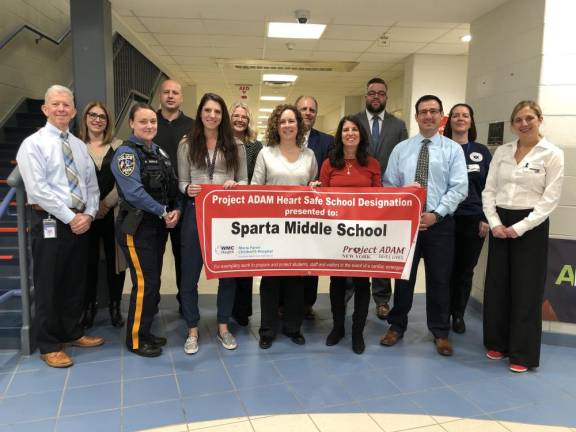 From left are Michael Gregory, director of operations; Assistant Superintendent Tara Rossi; Sparta Police Officer Paige Dewald; Sparta Police Detective Steven Guido; Sparta Middle School nurse Alexa Griffin; middle school Vice Principal Cherie Shefferman; Alice Schoen of Project ADAM; middle school Vice Principal Brad Davis; Dana Colasante of Project ADAM; Superintendent Matthew Beck; middle school Principal Frank Ciaburri; Kelly Stites of the Sparta Ambulance Squad; and Dr. Christa Miliaresis of Project ADAM. (Photo by Kathy Shwiff)
