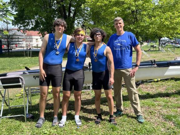 Tim Holovacs, right, the Sussex Rowing Club coach, poses with Pope John rowers, from left, Vincent Clerico, Christian Marlin and Andrew Wilson.