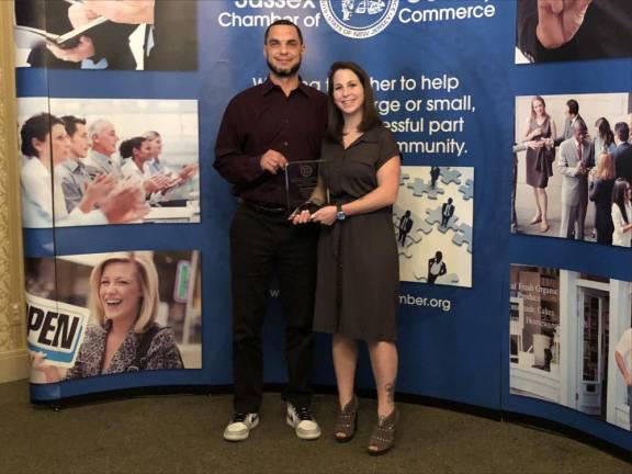 Benjamin and Heather Davey, founders of Benny’s Bodega in Newton, hold a Quality in Living Award from the Sussex County Chamber of Commerce. (Photo by Kathy Shwiff)