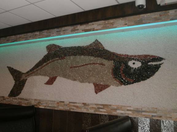 A 27 foot fish waterfall, designed with rocks gathered by the owner, decorates an interior wall.