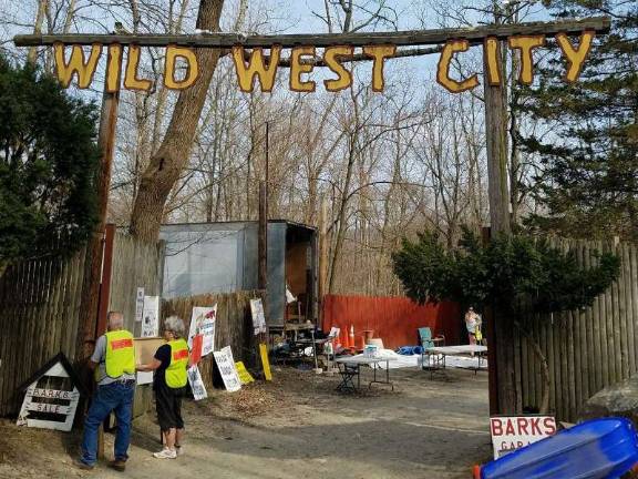 Volunteers bring the headboard of a purchased bed out to the parking lot for loading, at the BARKS' Semi-Annual Garage Sale, Saturday at Wild West City. Photos by Mandy Coriston